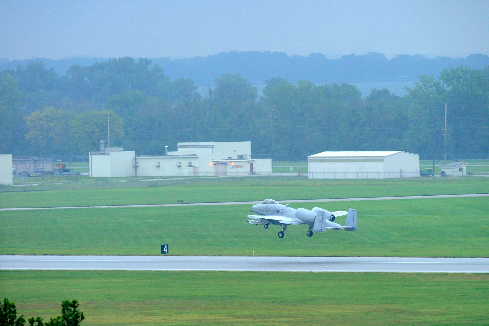 An A-10 Thunderbolt II aircraft takes off during an early morning rain at Selfridge Air National Guard Base, Mich., Aug. 10, 2012. Airmen from the 107th Fighter Squadron, who fly the aircraft, and the 127th Maintenance Group, who maintain the aircraft, participated in a surge operation, launching and recovering a higher-than-usual number of aircraft, as part of a series of readiness training exercises taking place at the base in August. (Air National Guard photo by John S. Swanson)