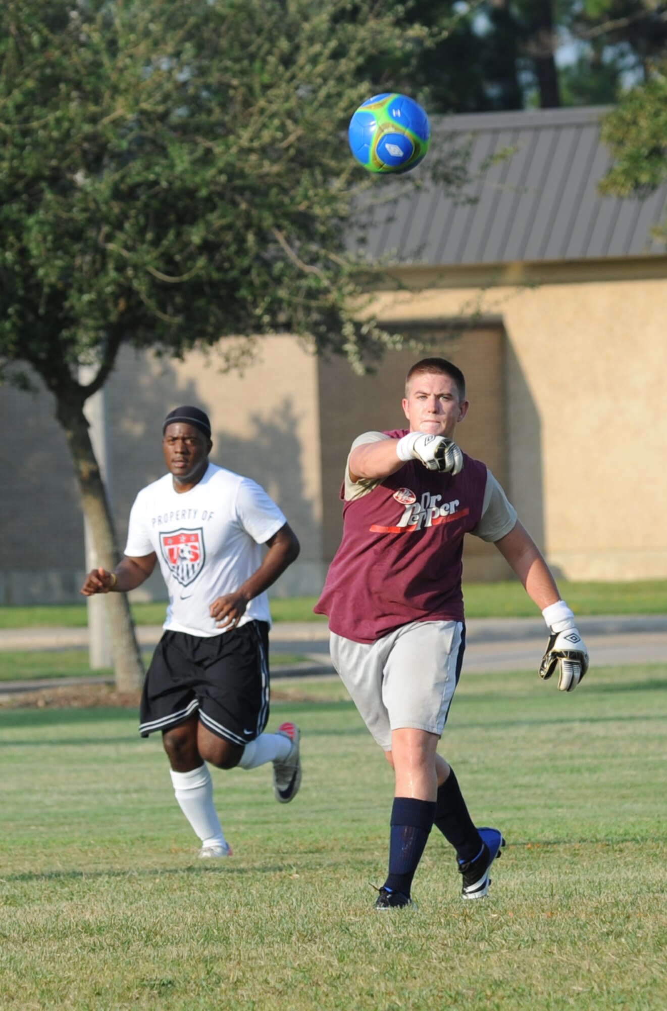 Logan Crandall, 85th Engineering Installation Squadron, throws the ball to a team mate as he plays the keeper position with Tony Bridgewater, 334th Training Squadron, right behind him in an intramural soccer game August 7, 2012, at Keesler Air Force Base, Miss.  The Gators defeated the 85th 6-2.  (U.S. Air Force photo by Kemberly Groue)