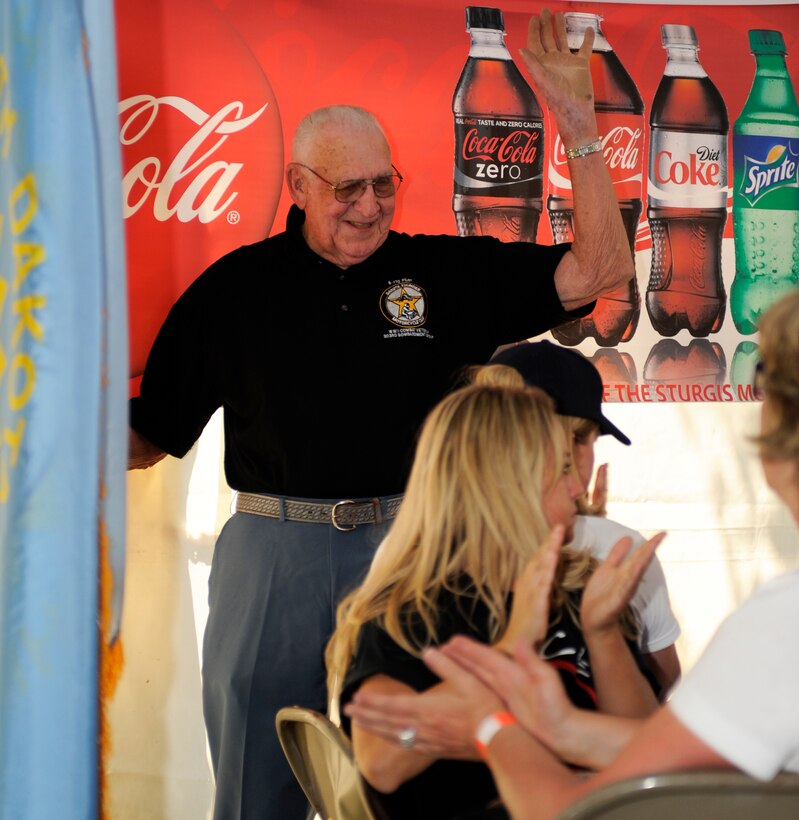 Retired Lt. Col. Donald Smith waves to friends and family during a ceremony in his honor for Military Appreciation Day in downtown Sturgis, S.D., Aug. 7, 2012. Smith spent 32 years in the Air Force serving as a co-pilot for B-17s and various other aircraft in 34 combat missions during World War II, Vietnam and the Korean War. (U.S. Air Force photo by Airman Ashley J. Cass/Released)