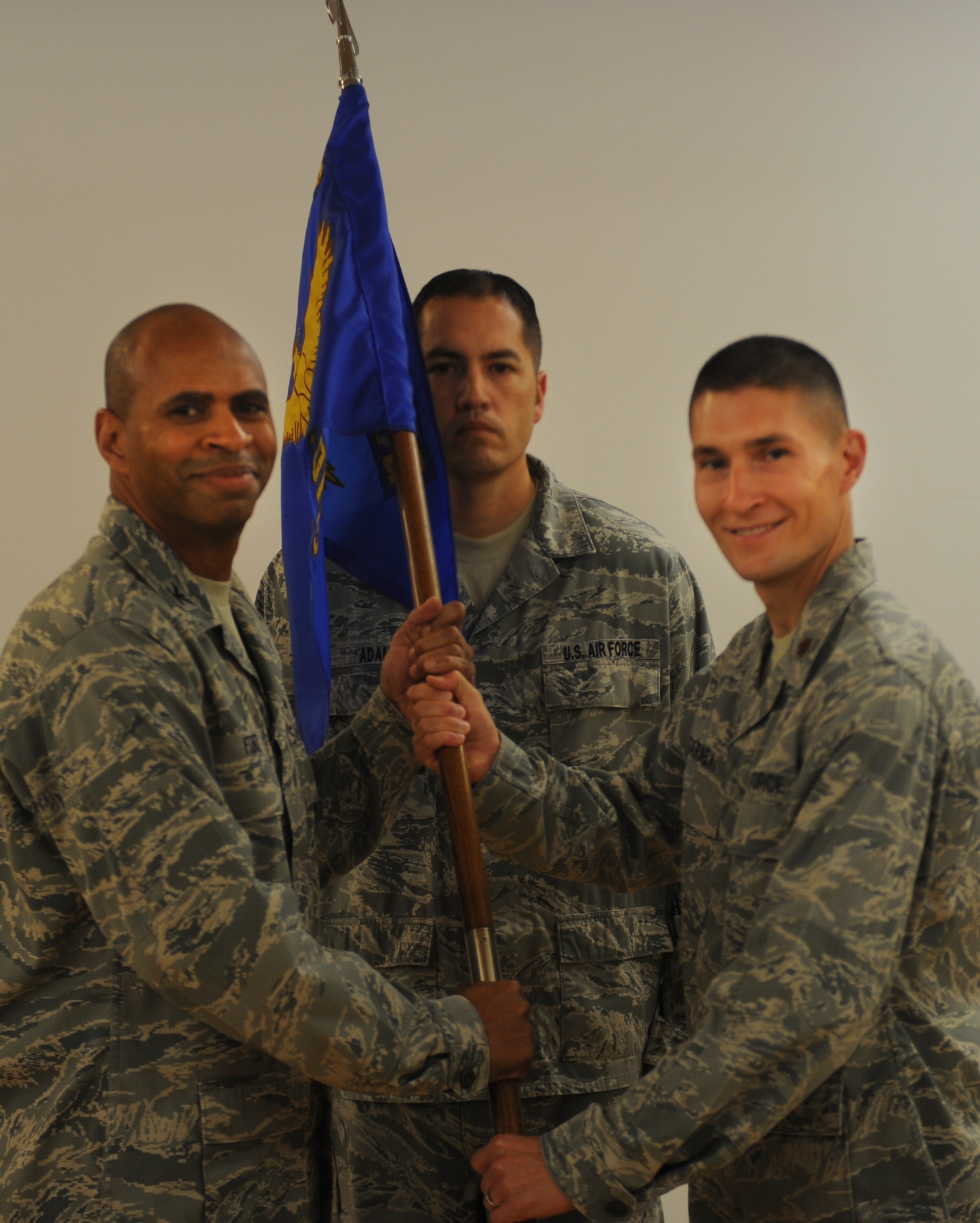 U.S. Air Force Col. Edward Ford, 23d Mission Support Group commander, passes the guidon to Maj. Jonathan Czarney, incoming 23d Contracting Squadron commander, during an assumption of command ceremony at Moody Air Force Base, Ga., Aug. 9, 2012. The ceremony is a military tradition that represented the official assumption of authority of the squadron to Czarney. (U.S. Air Force photo by Airman 1st Class Douglas Ellis/Released)
