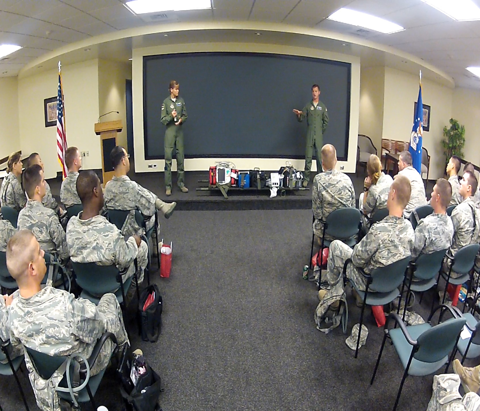 Aeromedical techs Master Sgt. Gregory Gaines and Staff Sgt. Brigid Dye, 315th Aeromedical Evacuation Squadron, explain AE missions and the roles of Chaplains on those missions. (U.S. Air Force photo / Michael Dukes)