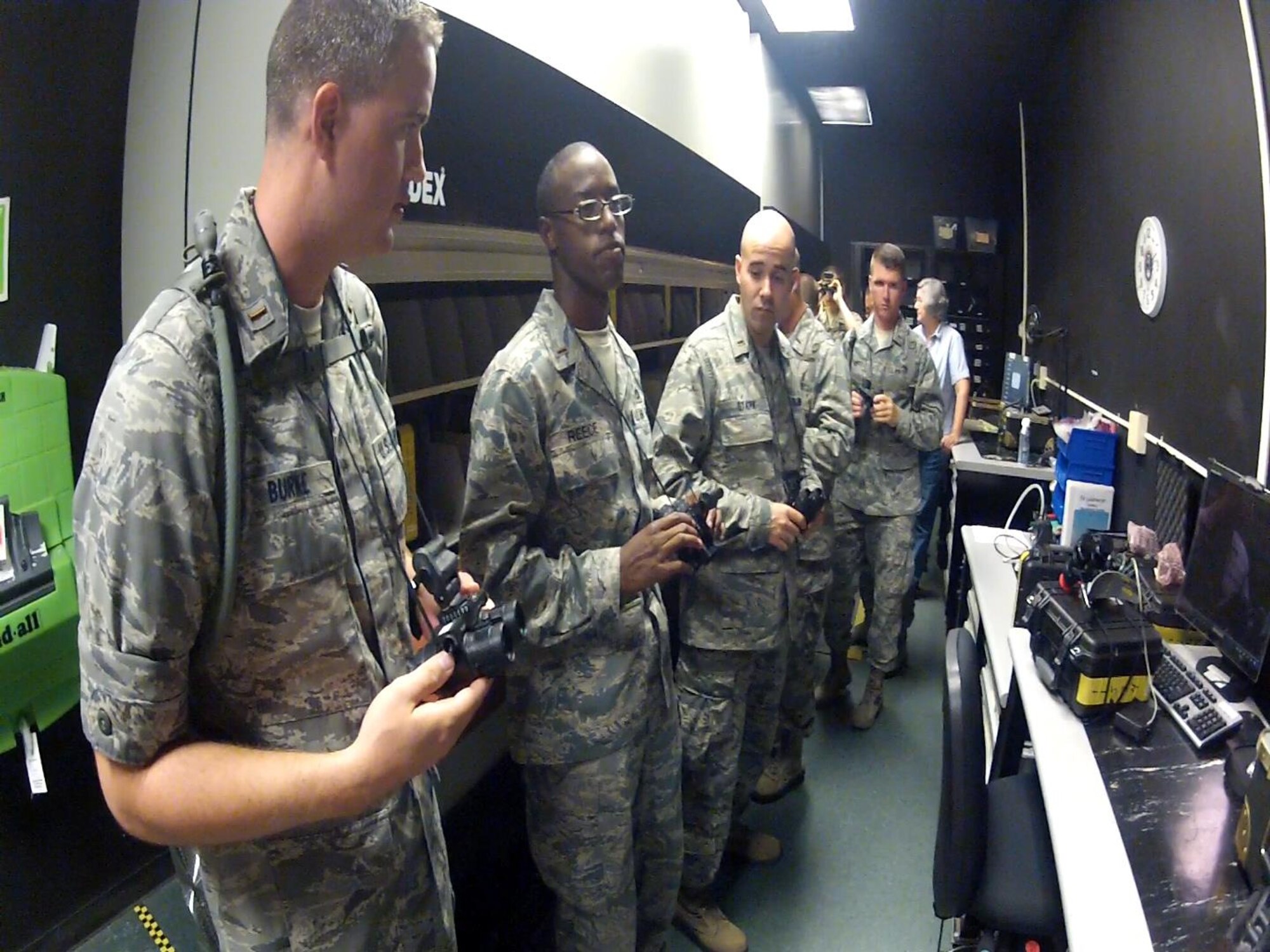 Chaplain candidates eagerly await the opportunity to try out a pair of night vision goggles at Joint Base Charleston Life Support during their visit Aug. 9, 2012. (U.S. Air Force photo / Michael Dukes)