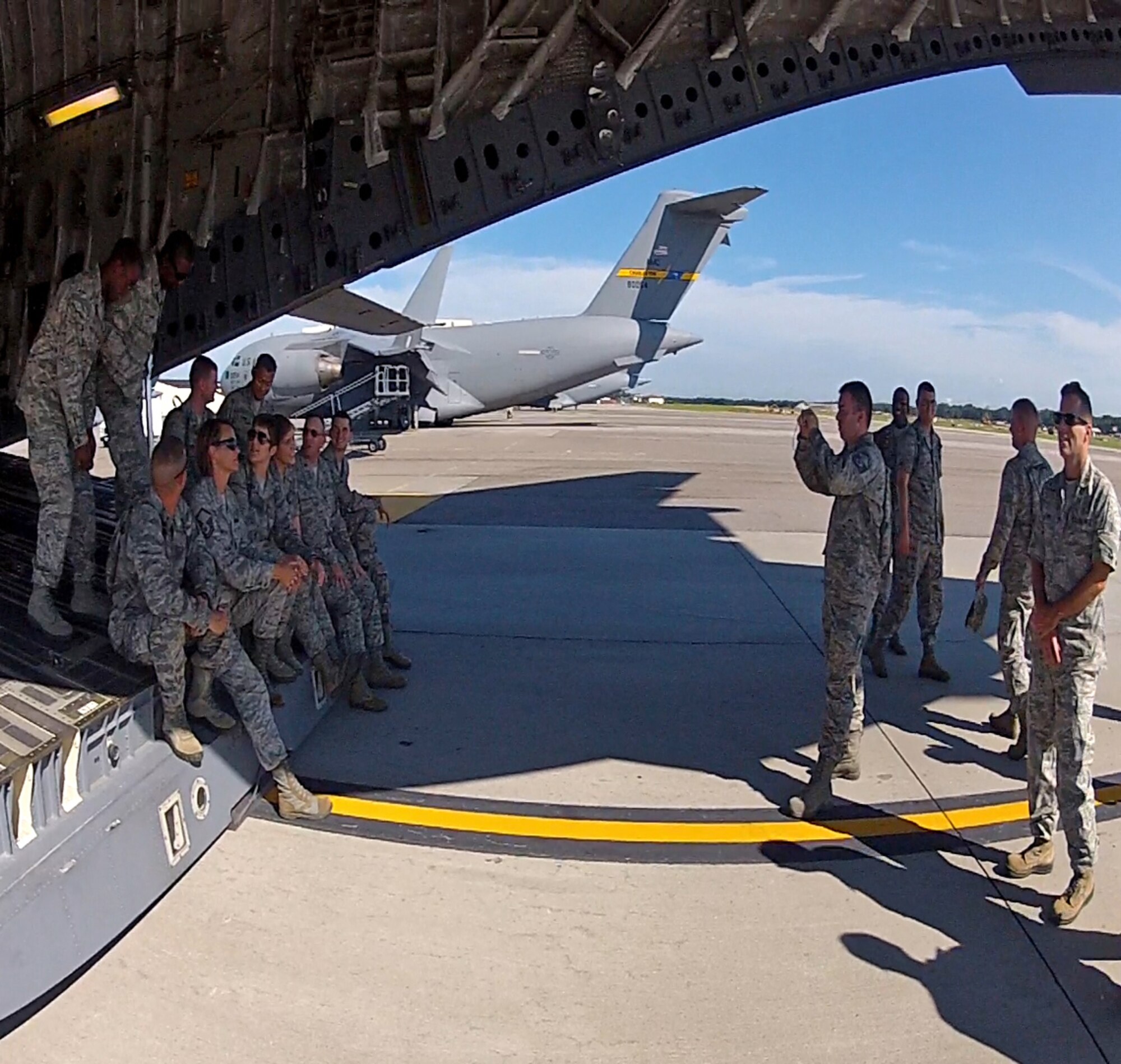 A Charleston yellow tail stands proudly in the background as Chaplain candidates pose for photos on the ramp of one of the the base's C-17 Globemaster IIIs during the  group's visit to Joint Base Charleston Aug. 9, 2012. (U.S. Air Force photo / Michael Dukes)