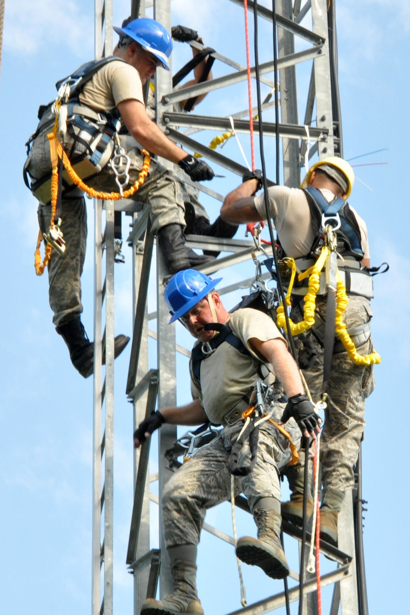 Tech. Sgt. Louis Hereford, reacts as he drops approximately eight inches after his tether line is cut away, leaving him connected only to Staff Sgt. Shannon Hamilton on a 90 foot radio tower during a simulated rescue at Barksdale Air Force Base, La., Aug. 9, 2012. Both Hamilton and Hereford, who are cyber operations technicians assigned to the 307th Force Support Squadron Communications Element, were on Annual Tour with the 608th Air Communications Squadron at Barksdale while attending a radio tower climbing certification class. (U.S. Air Force photo by Master Sgt. Jeff Walston)  