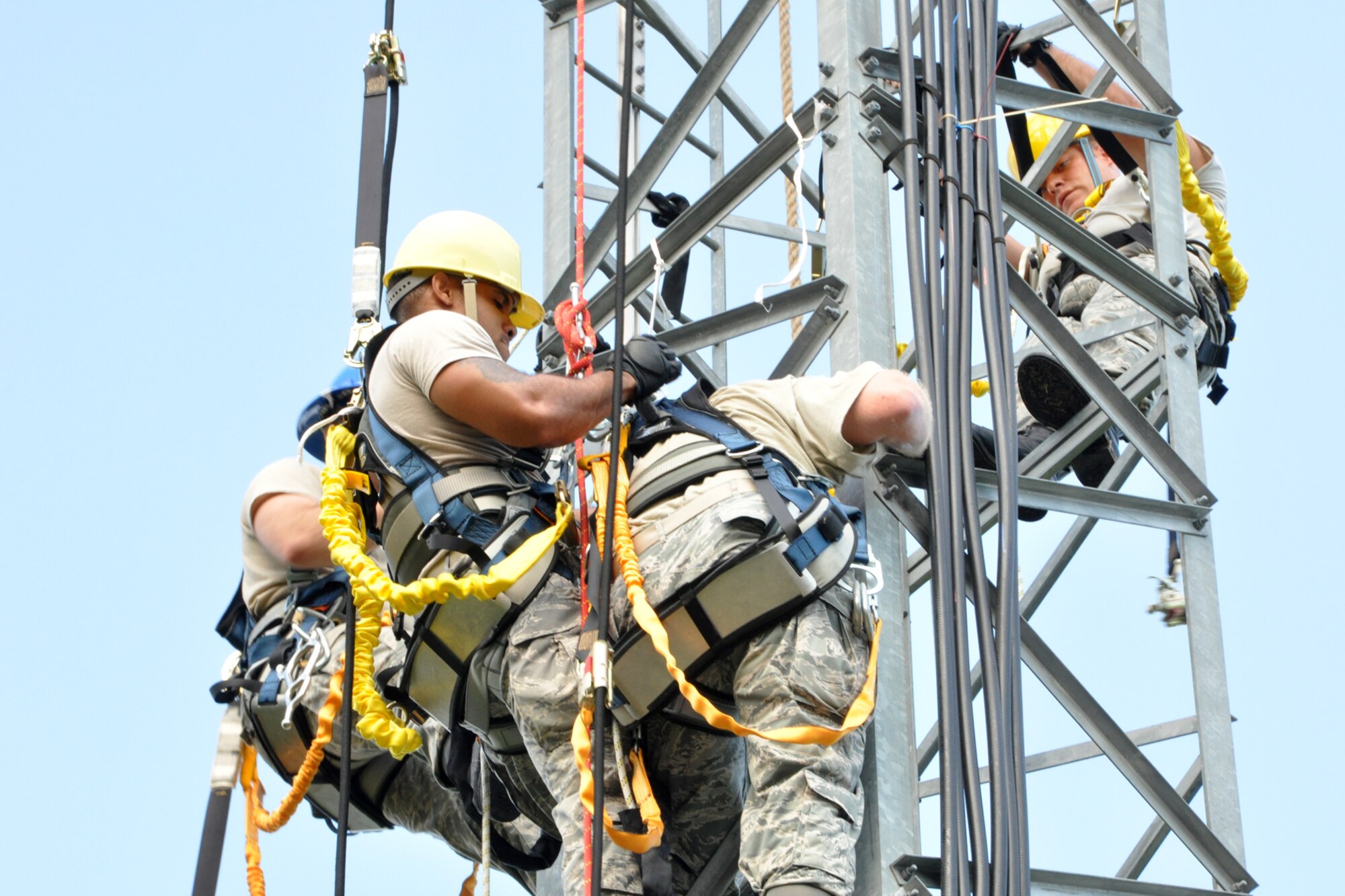 As instructors from the 608th Air Communications Squadron look on, Staff Sgt. Shannon Hamilton secures Tech. Sgt. Louis Hereford to his climbing gear in a simulated rescue on a 90 foot radio tower during a radio tower climbing certification class at the AOC Remote Transceiver Site on Barksdale Air Force Base, La., Aug. 8, 2012. Both Hamilton and Hereford, who are cyber operations technicians assigned to the 307th Force Support Squadron Communications Element, were on Annual Tour with the 608th Air Communications Squadron at Barksdale while attending the class. (U.S. Air Force photo by Master Sgt. Jeff Walston)  