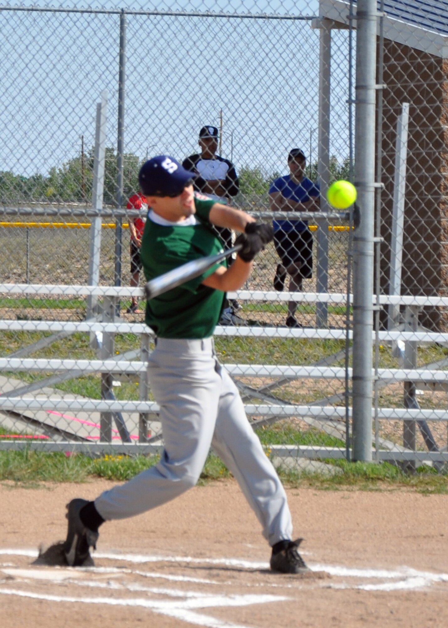 1st Lt. Michael Urbansky, Greentails, hits a line-drive in the F. E. Warren softball fields Aug. 4. The softball tournament was organized by the base’s Top 3 organization to raise funds for this year’s Senior NonCommissioned Officer Induction Ceremony. (U.S. Air Force photo by Capt. Angela Webb)
