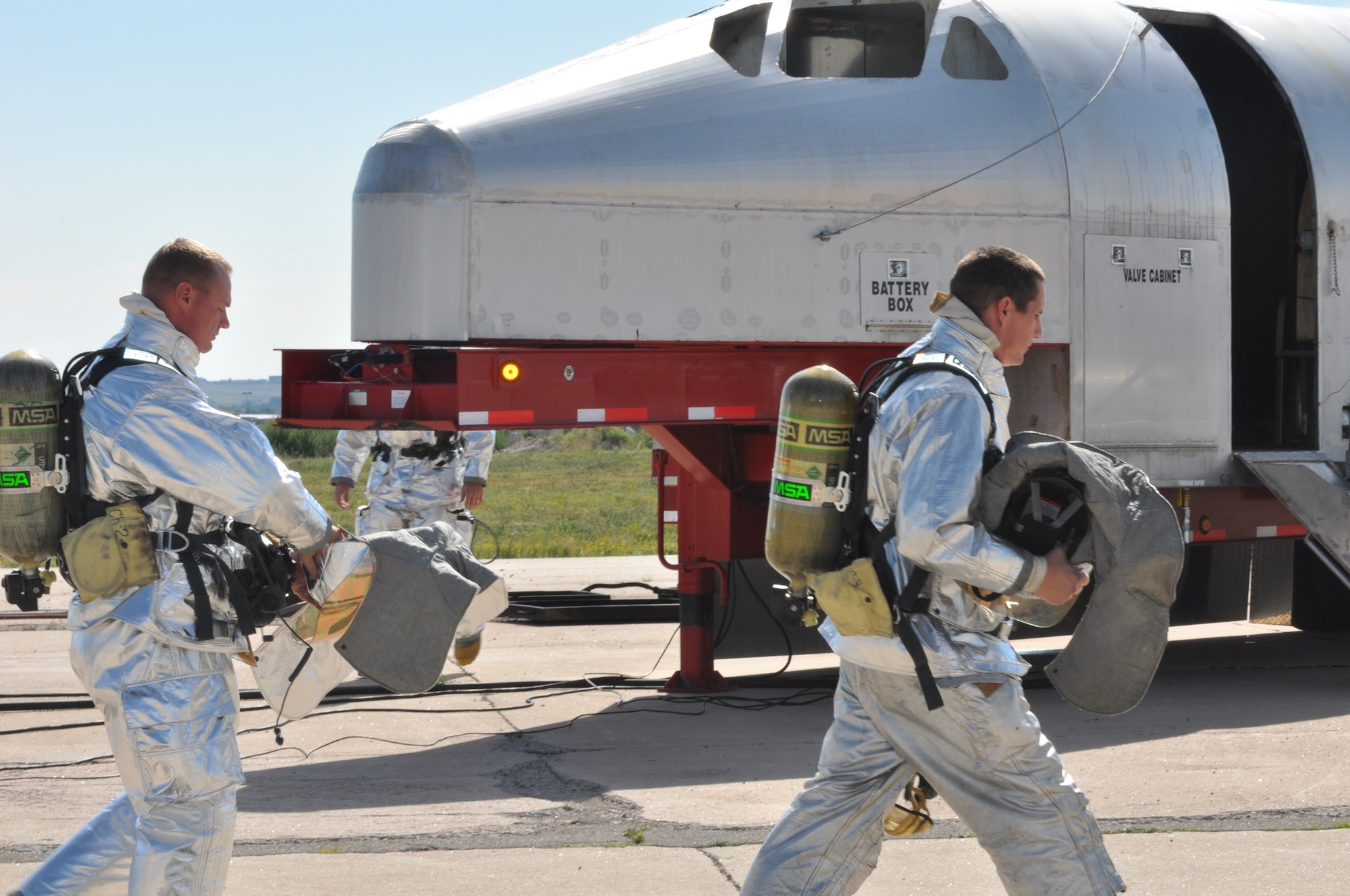 Members of the F. E. Warren Fire Department walk around the Mobile Air Fire Trainer prior to a training exercise Aug 3 at the Wyoming Air National Guard. Members of the Wyoming Air National Guard’s fire department, along with members of Warren’s fire department have completed approximately 20 exercises in the trainer since its arrival from Buckley Air Force Base, Colo. in June. (U.S. Air Force photo by Senior Airman Dan Gage)
