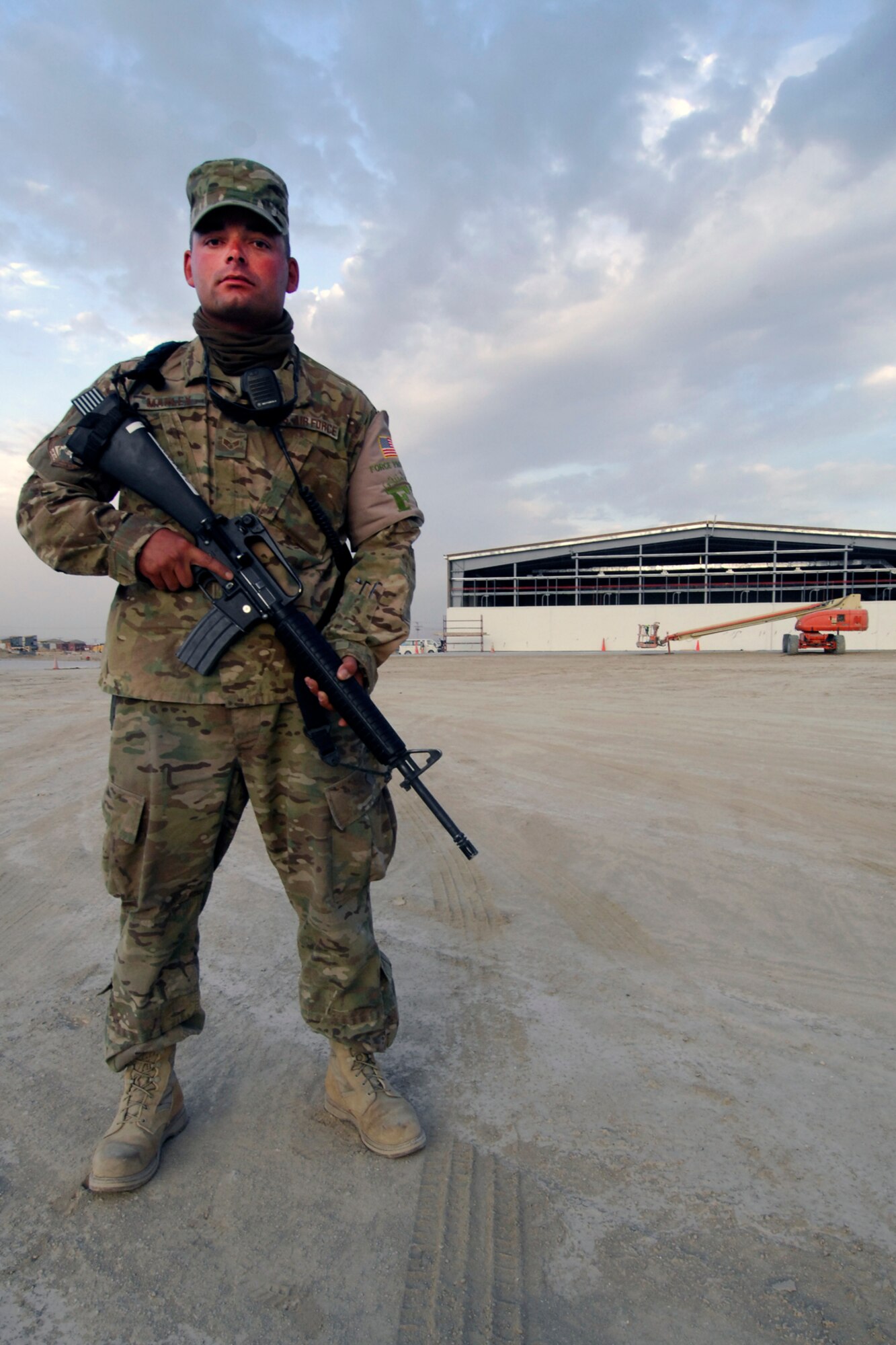 SrA Marvin Manley, 455th Expeditionary Civil Engineer Squadron Force Protection escort, stands guard over a construction site at Bagram Airfield, Afghanistan, Aug. 10, 2012. Manley escorts local nationals, foreign civilian employees and contractors who work on base. (U.S. Air Force photo/SSgt Jeff Nevison)