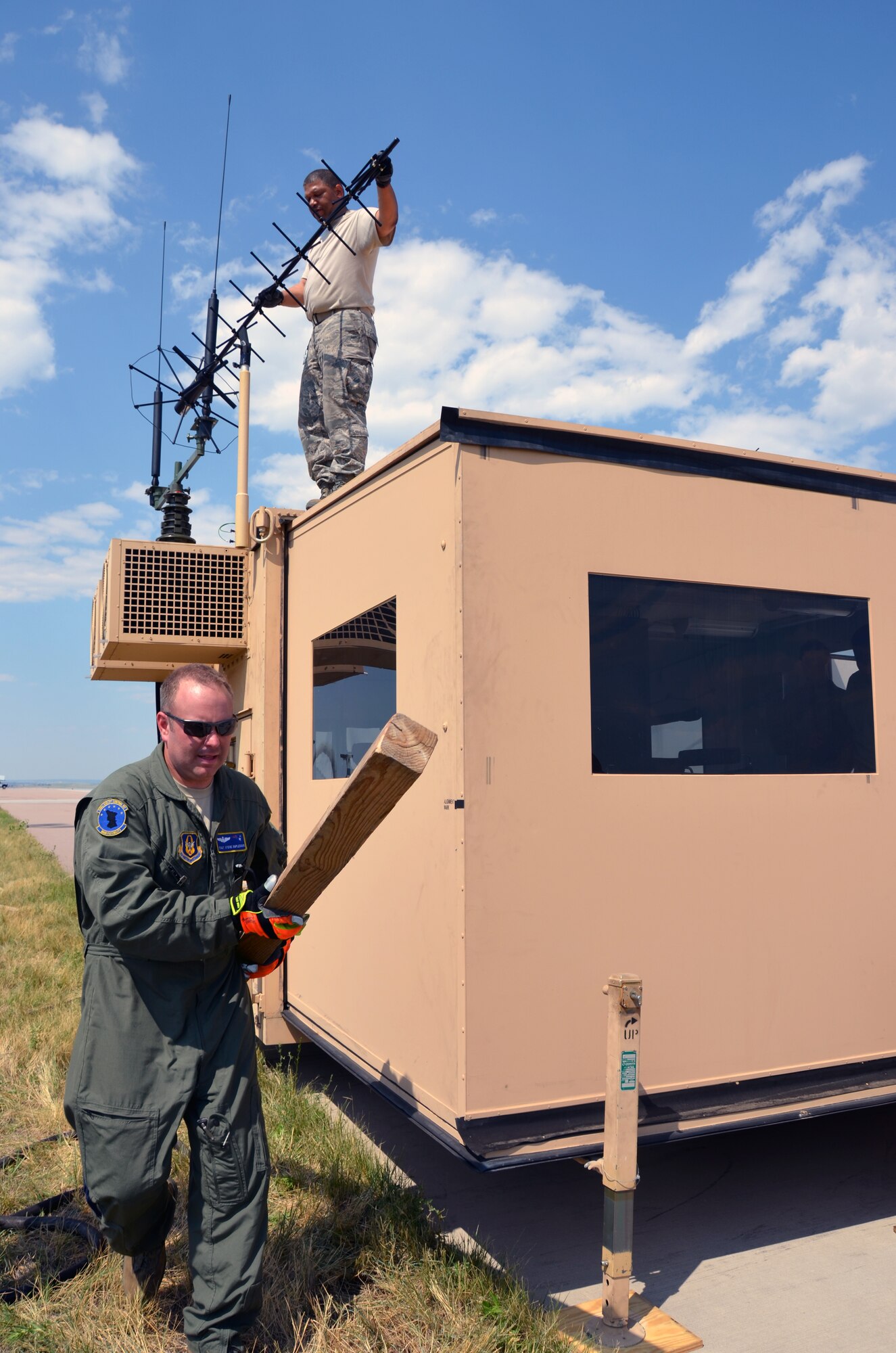 TSgt. Steve Duplessis and MSgt. Alex Cotton, both 439th Airlift Control Flight members, prepare the Hard Sided Expandable Light Weight Air Mobility Shelter Aug. 8. Five ALCF units reserve-wide are participating in Patriot Express, an annual Air Force Reserve Command exercise. (U.S. Air Force photo/ SrA. Kelly Galloway)