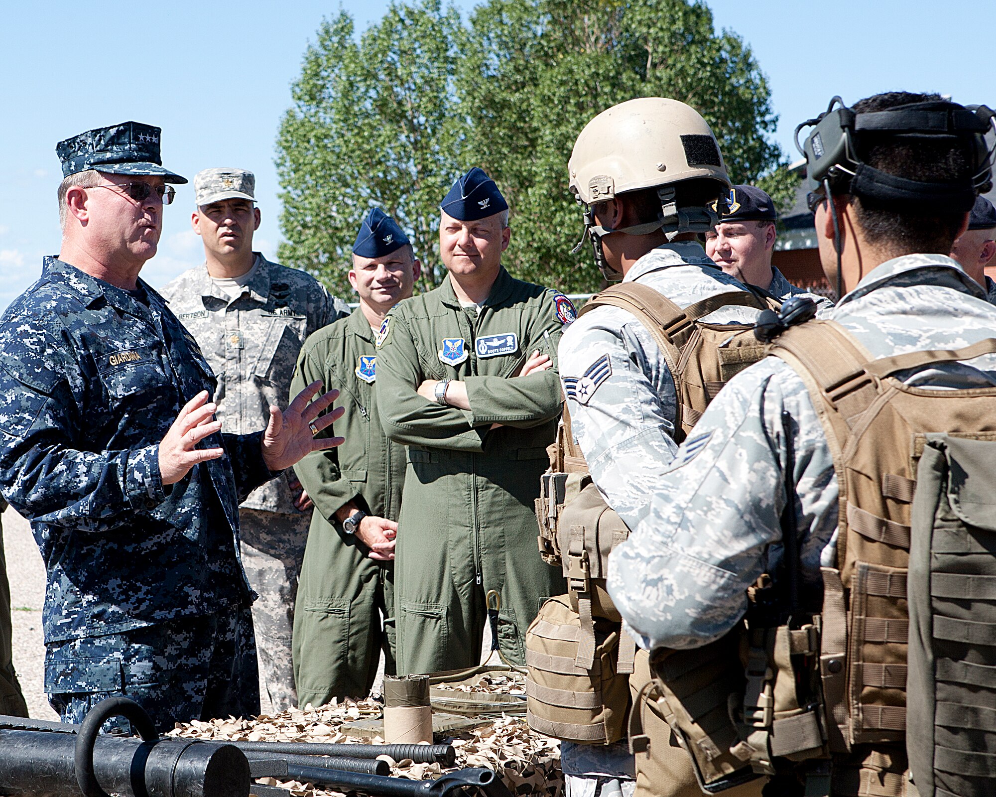 Navy Vice Adm. Timothy Giardina, United States Strategic Command deputy commander, speaks to members of the 90th Security Forces Group tactical response force team, while Col. Christopher Coffelt, 90th Missile Wing commander and Col. Donald Holloway, 90th Operations Group commander, look on. Giardina visited F. E. Warren Air Force Base, Wyo., from July 30 to 31, where he received a 90th MW mission orientation. (U.S. Air Force photo by Matt Bilden)
