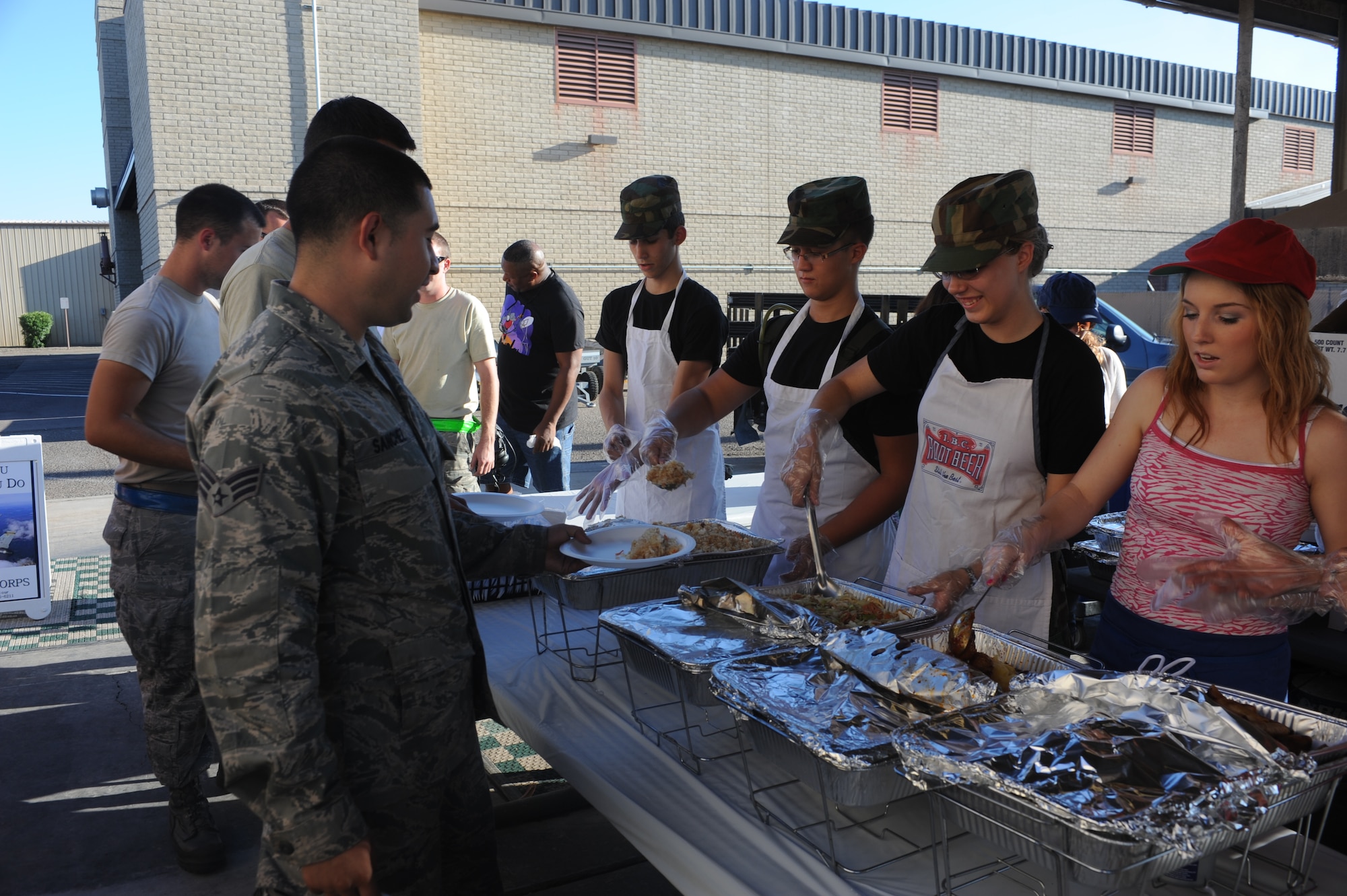 Civil Air Patrol cadets serve lunch to Airmen Aug. 1 during a flightline feast at Luke Air Force Base. CAP is a volunteer organization with an aviation-minded membership that has helped the Air Force and other agencies perform their missions. (U.S. Air Force photo by Airman 1st Class Devante Williams)