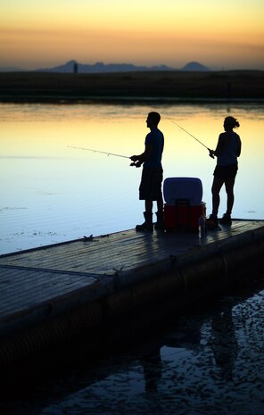 Michael Viel (left) and Senior Airman Megan Dunaway (right) fish at Lower Blackwelder Lake July 31, 2012 on Beale Air Force Base, Calif. Viel is a contractor with the 9th Maintenance Squadron and Senior Airman Dunaway is a maintainer with the 9th Aircraft Maintenance Squadron. (U.S. Air Force photo by Airman 1st Class Andrew Buchanan)