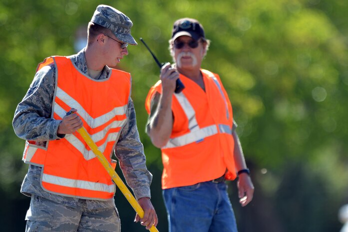 Members of the 9th Civil Engineering Squadron prepare Robert Nicolletti Way for one way traffic near the Beale Lanes bowling alley at Beale Air Force Base, Calif., August 2, 2012. The roadway between the Child Developement Center and Beale Lanes will indefinitely be open to one lane traffic as of August 2, 2012 to increase safety in the high pedestrian traffic area. (U.S. Air Force photo by Airman 1st Class Andrew Buchanan)