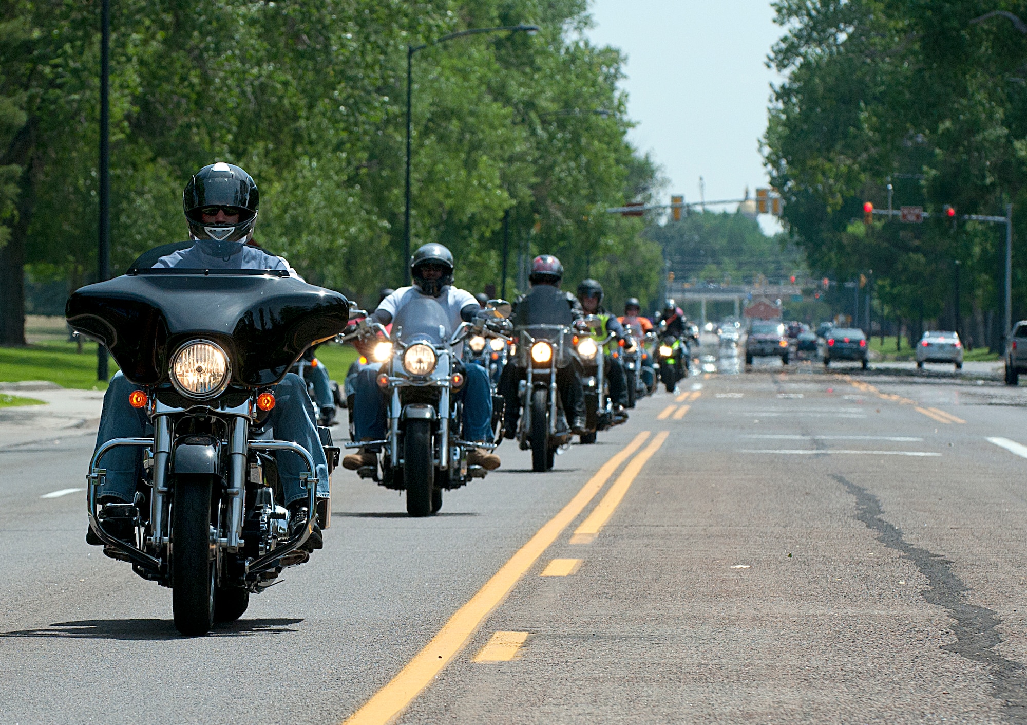 Motorcyclists role down Randall Boulevard on F.E. Warren Air Force Base Aug 3, as they return from of the Command Chief Motorcycle Mentorship Ride. The 90th Missile Wing safety office organized the roughly 100-mile ride to help younger riders learn from more experienced riders. (U.S. Air Force photo by R.J. Oriez)
