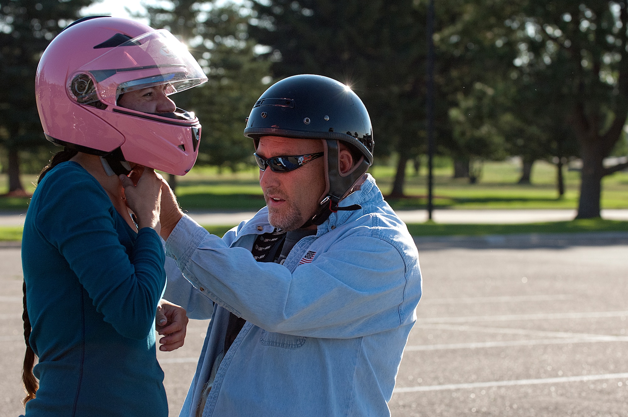 Troy Weaver helps Staff Sgt. Vanessa Harsh with her helmet before they depart on
the Command Chief Motorcycle Mentorship Ride Friday, August 3, 2012. Weaver and
Harsh are both with the 90th Missile Wing Safety Office which organized the ride to
help younger riders learn from more experienced riders. (U.S. Air Force photo by R.J. Oriez)
