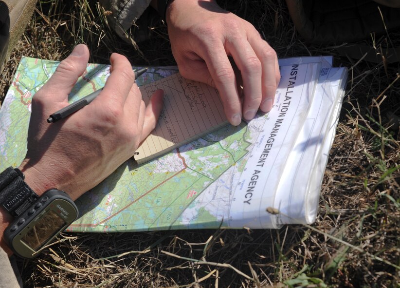 U.S. Air Force Senior Airman Yorke Goddard, 20th Air Support Operations Squadron joint terminal attack controller, writes coordinates during exercise Mountain Peak at Fort Drum, N.Y., July 25, 2012. When guiding aircraft, JTACs use the coordinates to provide an accurate location of targets. (U.S. Air Force photo by Airman 1st Class Douglas Ellis/Released)
