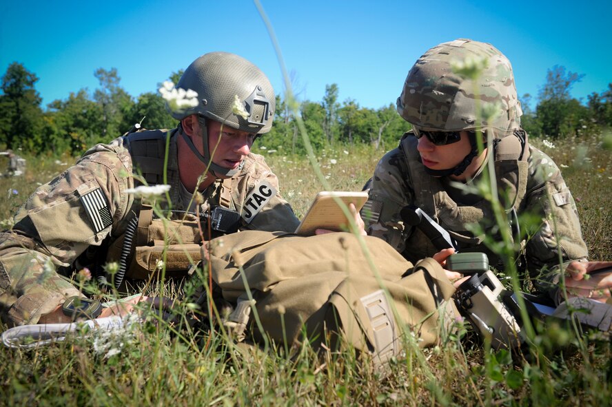 U.S. Air Force Senior Airman Yorke Goddard, 20th Air Support Operations Squadron joint terminal attack controller, and Airman 1st Class Titus Baker, 20th ASOS radio operator, maintenance and driver, prepares to call in an airstrike during exercise Mountain Peak at Fort Drum, N.Y., July 25, 2012. More than 10,000 Soldiers and Airmen worked together during Mountain Peak to prepare for future joint deployments. (U.S. Air Force photo by Airman 1st Class Douglas Ellis/Released)
