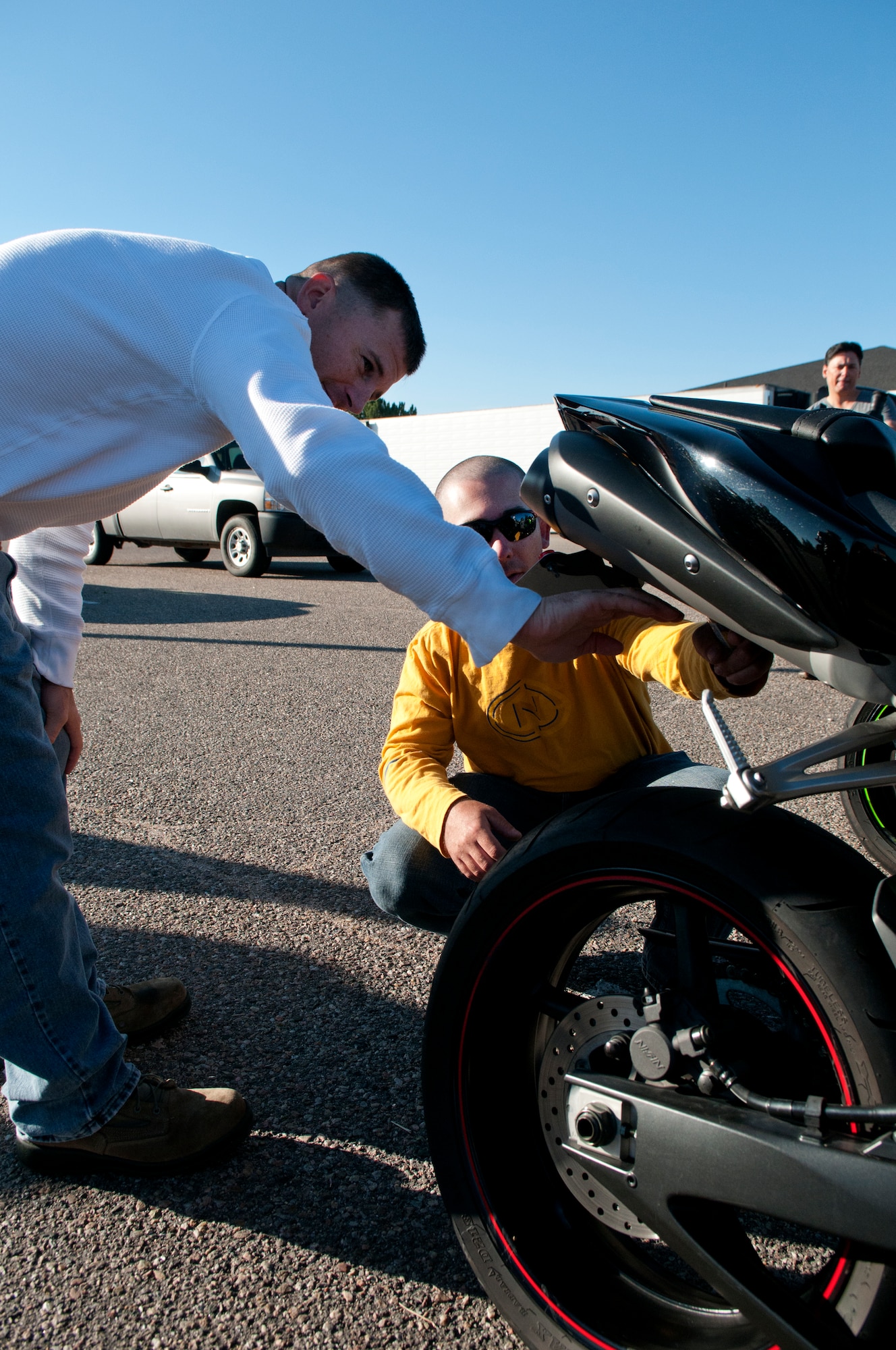 Tech. Sgts. Chris Hargis and Roger Protte, both with 90th Logistical Readiness
Squadron, discuss the mechanics of a motorcycle Friday, August 3, 2012, in the
Trail’s End Club parking lot before the start of the Command Chief Motorcycle
Mentorship Ride. The 90th Missile Wing safety office organized the ride to help
younger riders learn from more experienced riders. (U.S. Air Force photo by R.J. Oriez)

