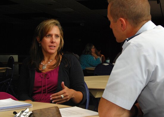 Tina Erzen and Col. Andy Szmerekovsky conduct a short mentoring session during a class on mentoring at the Air Force Academy Aug. 6.  (U.S. Air Force Photo/Don Branum)