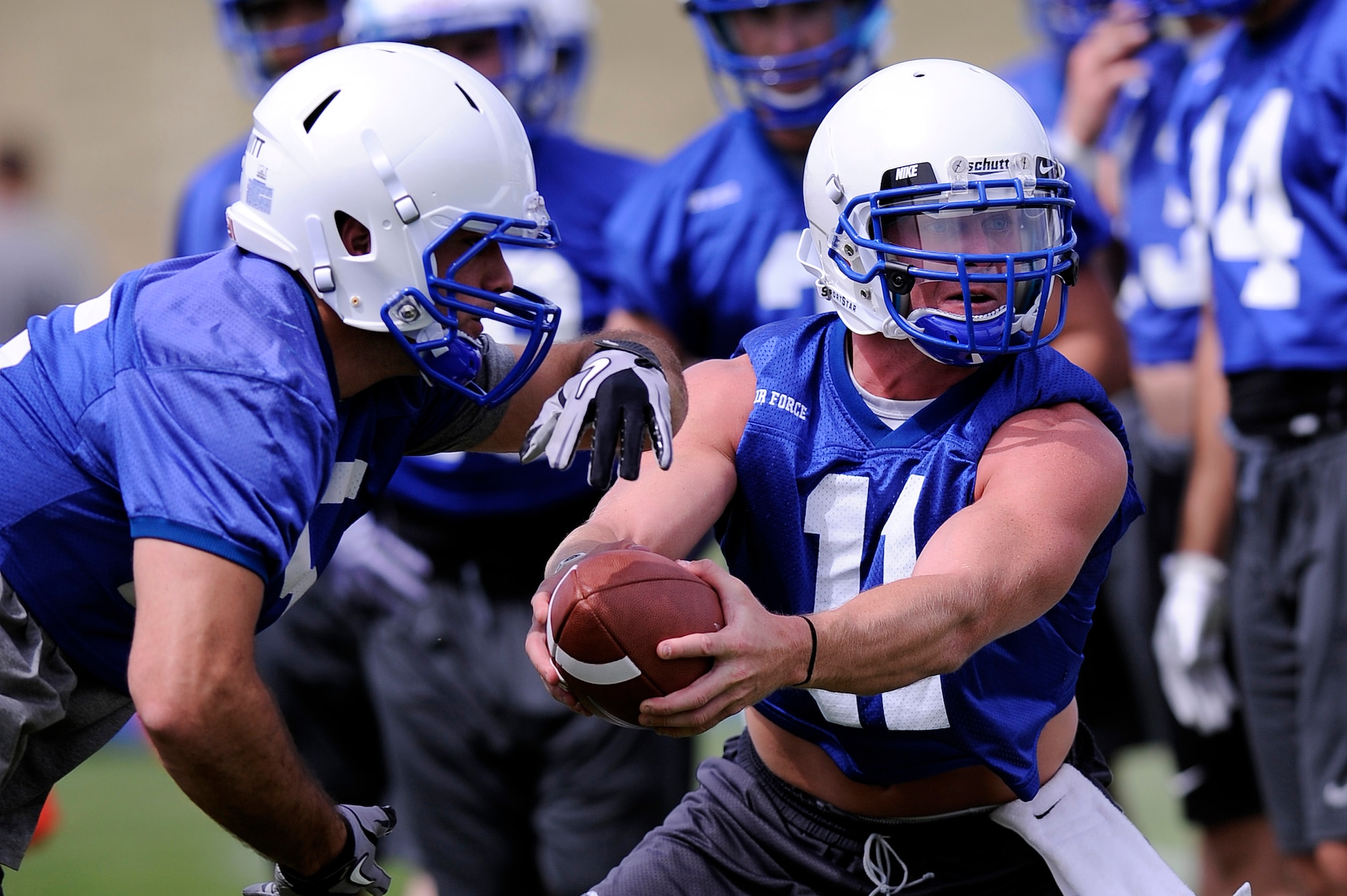 Air Force senior quarterback Connor Dietz hands off the ball to Senior fullback Mike DeWitt during practice Aug. 3.  (U.S. Air Force Photo/Mike Kaplan)