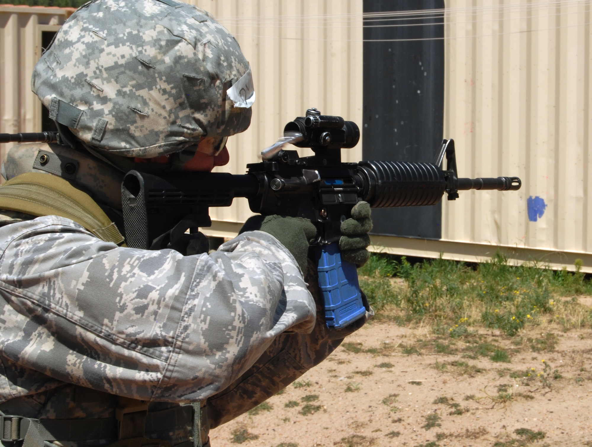 An Airman trying out for air liaison officer school test fires an M-4 carbine loaded with simulated munitions during mobile operations in urban terrain training at the Air Force Academy Aug. 5.   (U.S. Air Force Photo/Don Branum)