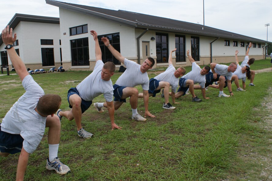 Airmen from the 366th Training Squadron Field Training Detachment 3 at Eglin Air Force Base, Fla., stretch out during Battlefield Survivability through Physical Fitness training July 19, 2012.  The program, designed to help Explosive Ordnance Disposal candidates get prepared for the rigors of deployed operations, was instituted in January 2012. (U.S. Air Force photo/Dan Hawkins)