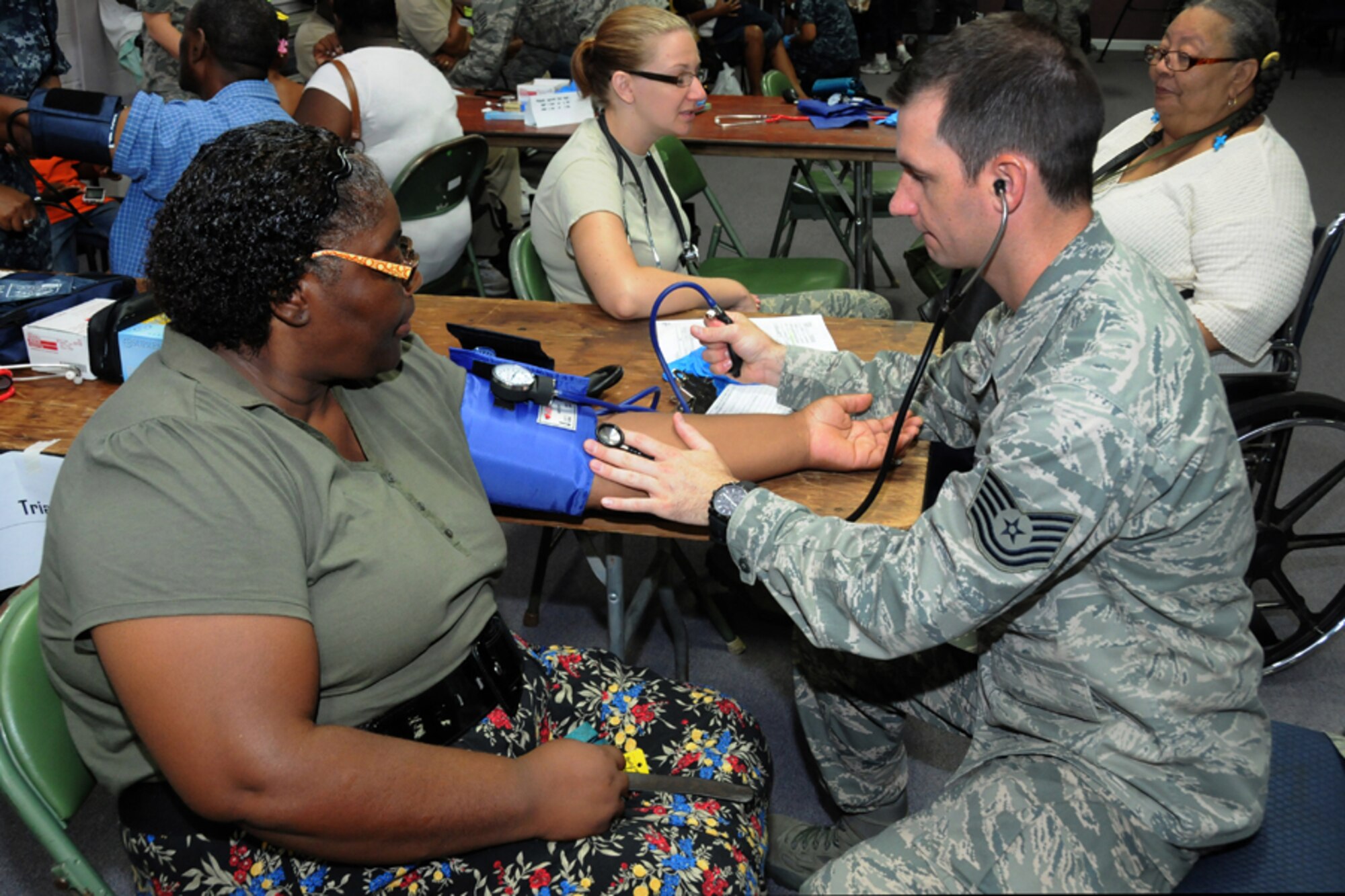 Tech. Sgt. Jacob Nugent, 123rd Medical Group, Kentucky Air National Guard, checks the blood pressure of an Alabama resident, while fulfilling his duties as medical staff noncommissioned officer in charge at a Selma medical clinic during the Innovative Readiness Training mission Alabama Care 2012 in Selma, Ala. Aug. 8, 2012. IRT Alabama Care 2012 is an Air National Guard led, multiservice mission comprised of active, reserve, and National Guard members from Army, Navy and Air Force components providing service members with readiness training while providing Alabama residents with free health services such as dental, optometry and medical screenings in the medically underserved and economically depressed community of Selma, Ala. Aug. 7-14, 2012. (National Guard photo by Tech. Sgt. Melissa E. Chatham/RELEASED)