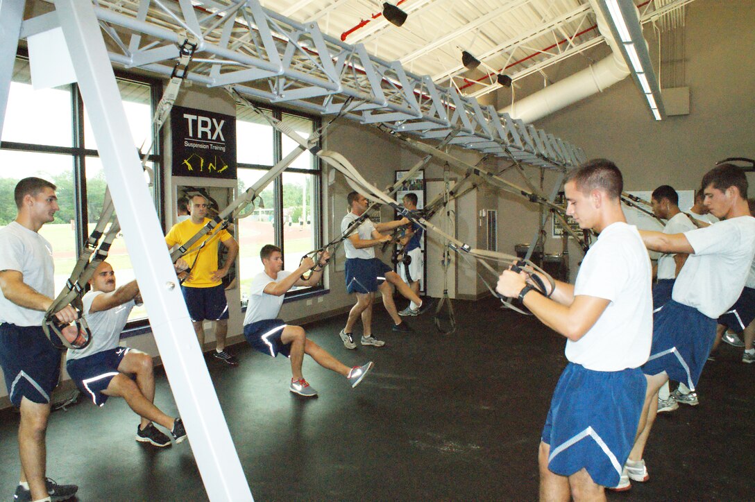 Airmen-in-Training from the 366th Training Squadron Field Training Detachment 3 work in the weight room during Battlefield Survivability through Physical Fitness training July 19, 2012 at Eglin Air Force Base, Fla.  The four-phase program is designed to last eight months long, corresponding with length of time students are at Naval School Explosive Ordnance Disposal. (U.S. Air Force photo/Dan Hawkins)