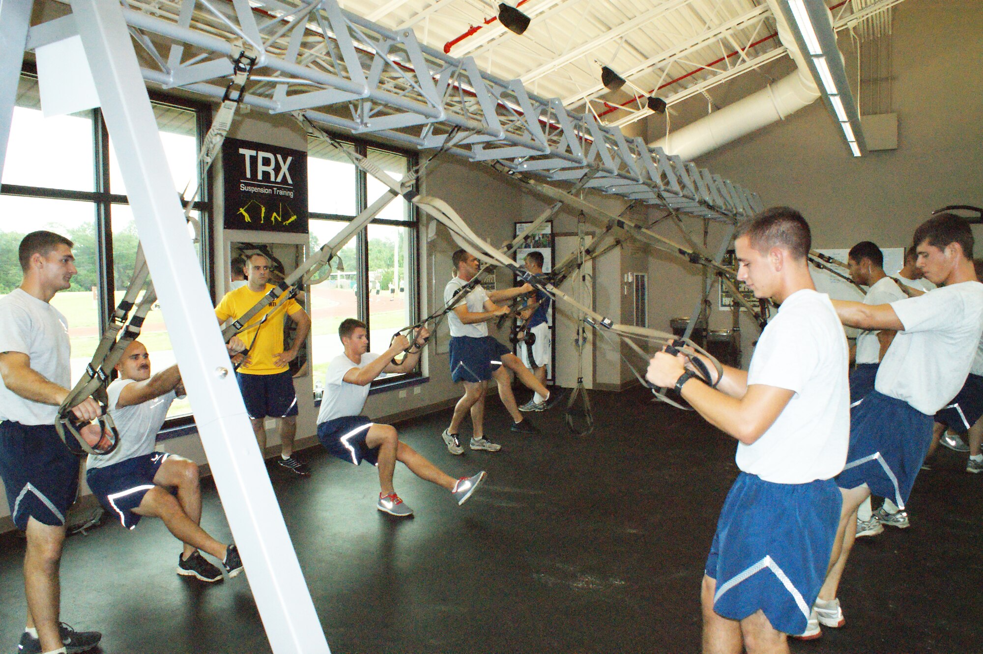 Airmen-in-Training from the 366th Training Squadron Field Training Detachment 3 work in the weight room during Battlefield Survivability through Physical Fitness training July 19, 2012 at Eglin Air Force Base, Fla.  The four-phase program is designed to last eight months long, corresponding with length of time students are at Naval School Explosive Ordnance Disposal. (U.S. Air Force photo/Dan Hawkins)