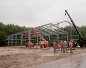 YOUNGSTOWN AIR RESERVE STATION, Ohio -- U.S. Air Force Reserve civil engineers place roof supports on a structure at Youngstown Air Reserve Station's civil engineer training site. The training site, which is expected to be completed toward the end of summer, offers valuable training to civil engineer squadrons from several units, while adding usable training/exercise structures to YARS. U.S. Air Force photo by Mr. Eric White.