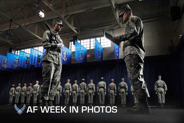 Airman Basic Jason Ortega, left, holds his M14 rifle while Staff Sgt. Robert Barnhart writes notes during an evaluation at the U.S. Air Force Honor Guard at Joint Base Anacostia-Bolling, Washington, D.C., July 26, 2012. Ortega and fellow Airmen are training to be part of the U.S. Air Force Honor Guard. Barnhart is an instructor with the honor guard. (U.S. Air Force photo/Val Gempis)