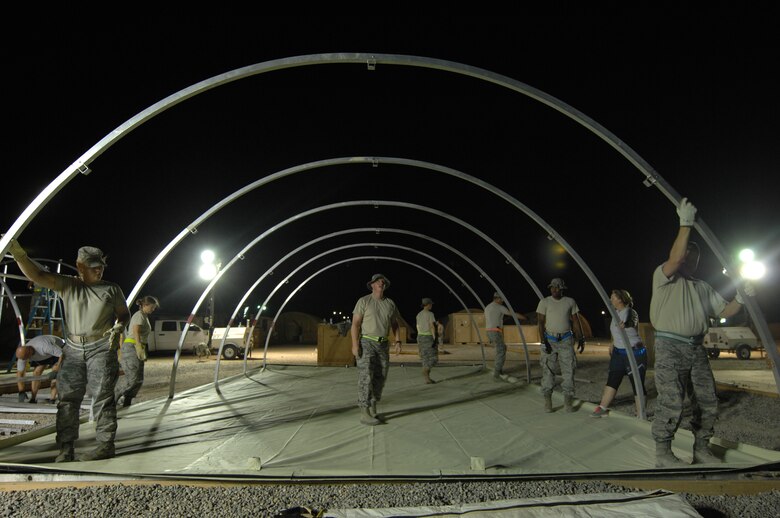 SOUTHWEST ASIA –Several Airmen around the wing took time out of their busy schedule to build more tents in preparation for inbound and outbound personnel here July 12. When the eight-man 386th Expeditionary Civil Engineer Squadron structures shop Airmen are not working on a major project, they are constantly in demand, doing various jobs around base. Approximately 200 work orders are submitted a week to their shop. (U.S. Air Force photo/Staff Sgt. Alexandra M. Boutte)