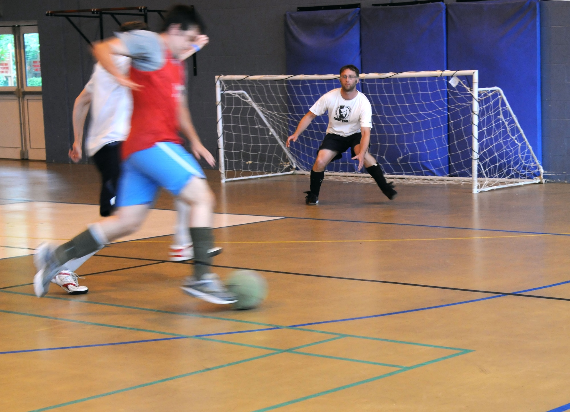 RAF MILDENHALL, England – Barry King, 100th Civil Engineering Squadron goalie, keeps his eye on the ball during the intramural indoor soccer game at the North Side Fitness Center Aug. 9, 2012. King made a series of saves which helped secure CES’s win. (U.S. Air Force photo/Airman 1st Class Kelsey Waters)