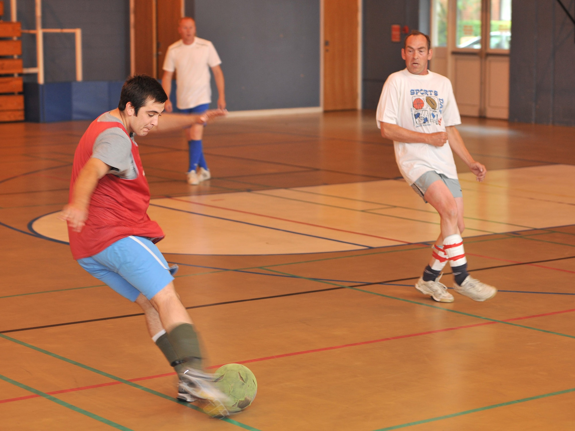 RAF MILDENHALL, England – David Cooper, 100th Maintenance Squadron, takes a shot during the intramural indoor soccer championship game Aug. 9, 2011 at the North Side Fitness Center. The 100th Civil Engineer Squadron went on to win the game with a final score 9-2. (U.S. Air Force photo/Senior Airman Jerilyn Quintanilla)