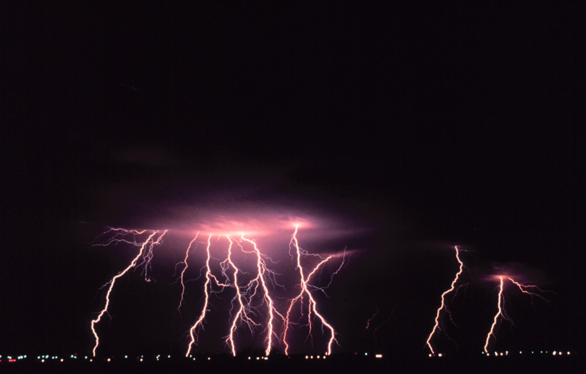 Time-lapse photography captures multiple cloud-to-ground lightning strokes during a night-time thunderstorm.  (Photo courtesy of the National Severe Storms Laboratory)