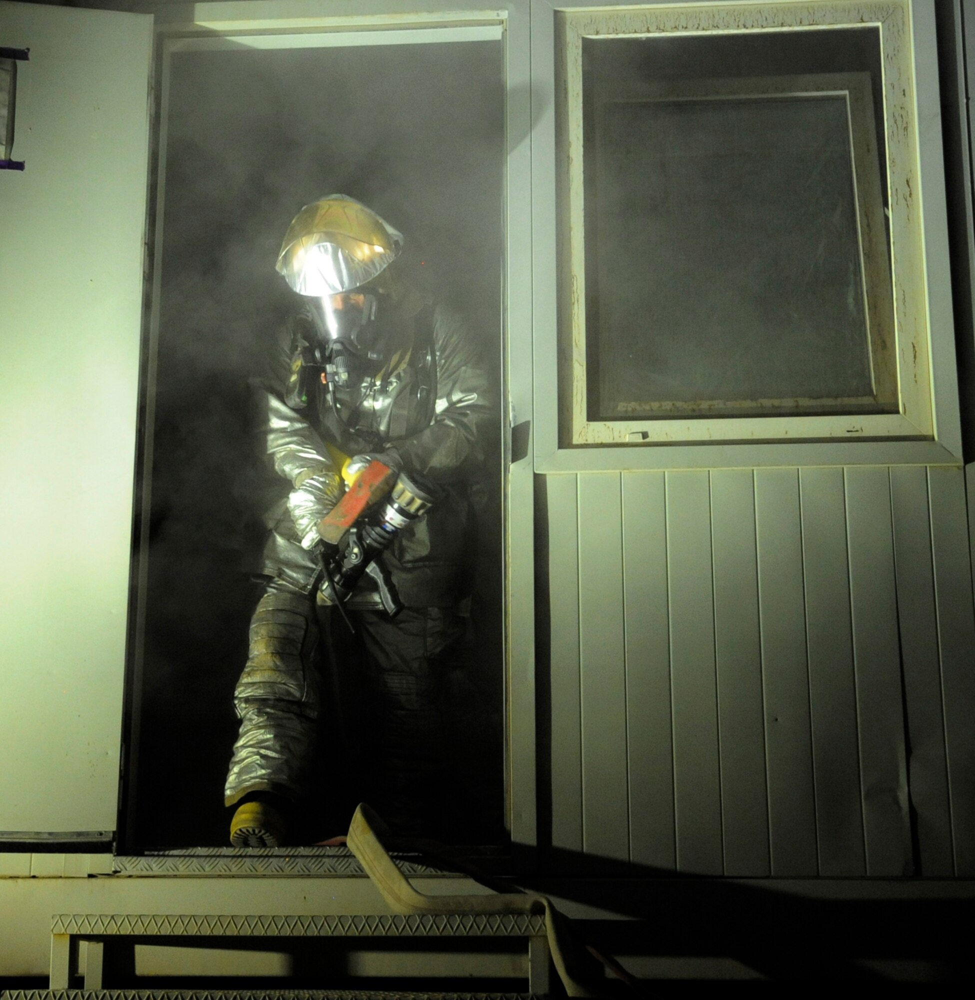 SOUTHWEST ASIA – A 386th Expeditionary Civil Engineer Squadron fire fighter, clears the smoking building of simulated victims during a practical exercise here August 7. The training gives the fire fighters a real-time visual of the incident and through their actions of trying to mitigate the emergency; they are learning through training and by working with other Airmen on how to complete the emergency safely without loss of life or danger to their crew. (U.S. Air Force photo/Staff Sgt. Alexandra M. Boutte)

