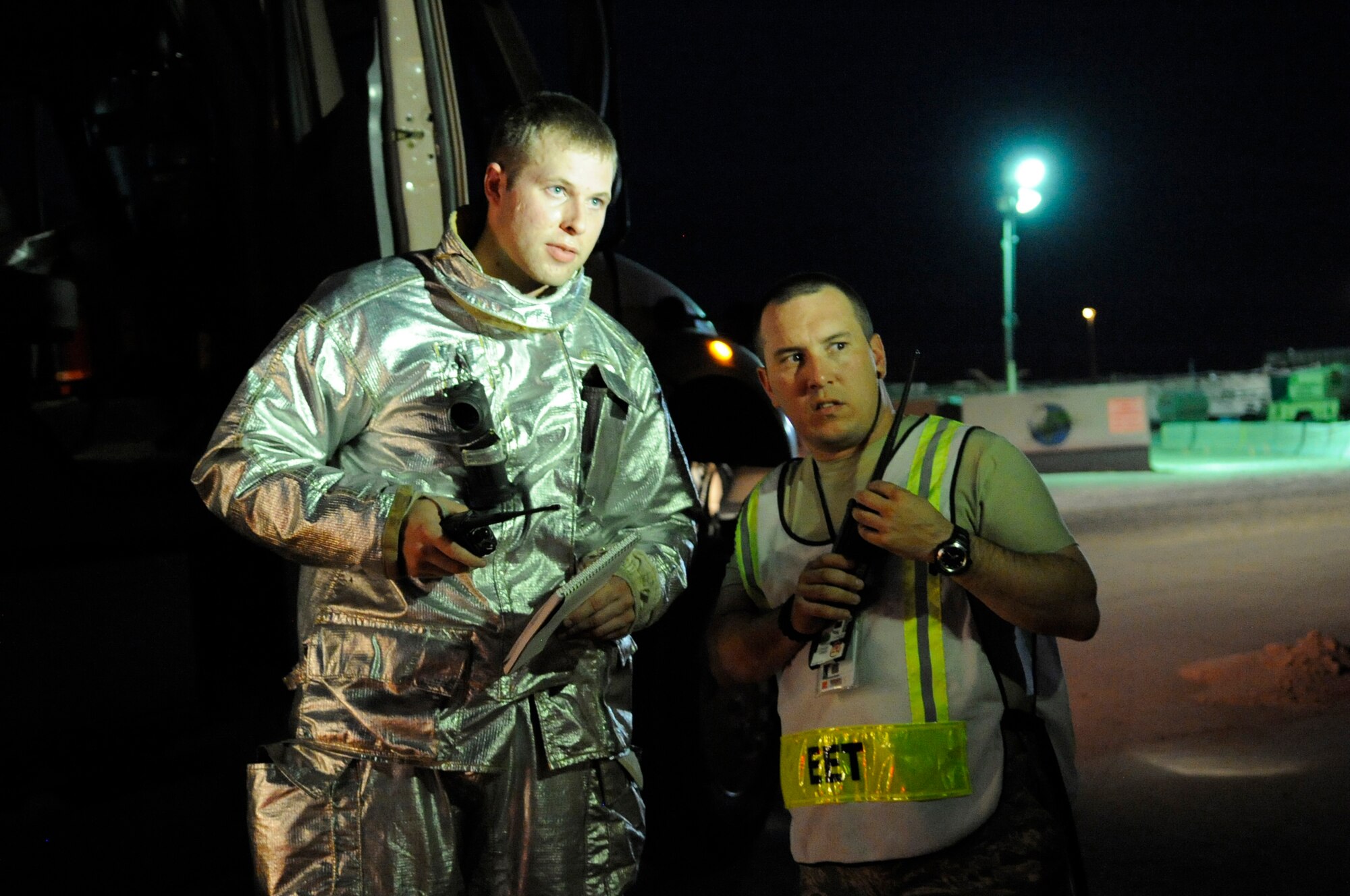 SOUTHWEST ASIA – Senior Airman Jarvis Ness, 386th Expeditionary Civil Engineer Squadron firefighter, discusses his actions to Master Sgt. Allan Martin, 386th ECES fire department assistant chief of training operations, during Ness’s practical exam here August 7. Ness completed his seven-level upgrade training during this exercise. (U.S. Air Force photo/Staff Sgt. Alexandra M. Boutte)