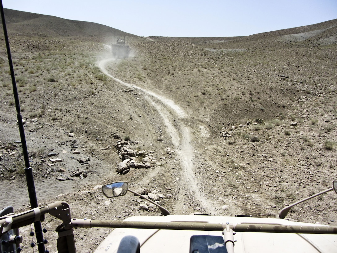 KANDAHAR PROVINCE, Afghanistan — A view of the way ahead, taken from the gunner's turret on an M-ATV, shows the difficult terrain that the column had to move through. David Nishimura and Sgt. 1st Class Gary Malkin, of the 565th Engineer Detachment (FEST-A), conducted a route reconnaissance mission in Shah Wali Kot district, Kandahar province, Afghanistan, on July 26, 2012.
