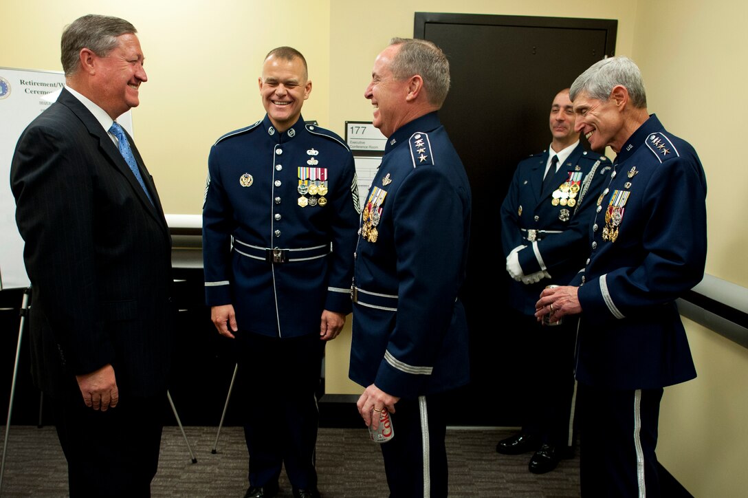 Air Force Secretary Michael B. Donley, left, James A. Roy, chief master sergeant of the Air Force, and Air Force Gens. Mark A. Welsh III and Norton A. Schwartz, right, share a laugh before the transition ceremonies during which Welsh succeeded Schwartz as the 20th chief of staff on Joint Base Andrews, Md., Aug. 10, 2012.