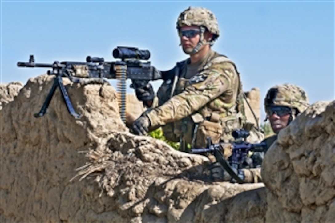 U.S. Army Pfcs. Kyle Peters and Justin Ford scan the horizon after taking fire from insurgents in the Panjwai district in southern Afghanistan's Kandahar province, July 30, 2012. Peters and Ford are assigned to Company A, 1st Battalion, 23rd Infantry Regiment.