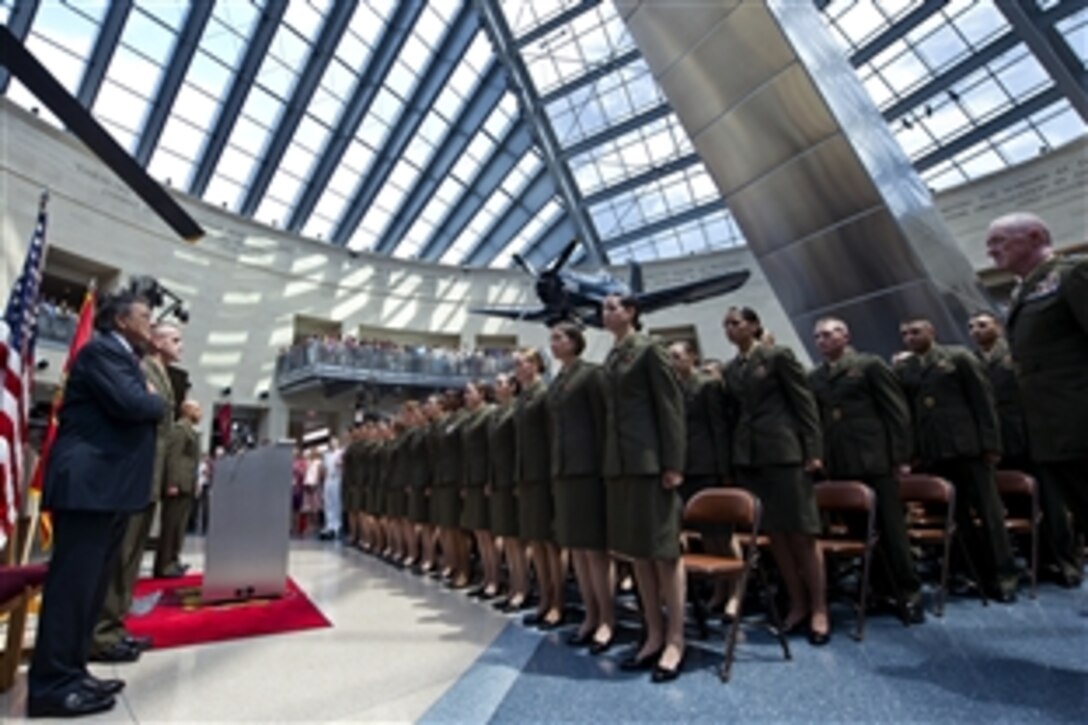 Defense Secretary Leon E. Panetta and newly commissioned Marine Corps 2nd lieutenants stand for the national anthem at the Marine Corps Officer Candidates School commissioning ceremony at the National Museum of the Marine Corps in Triangle, Va., Aug. 10, 2012.