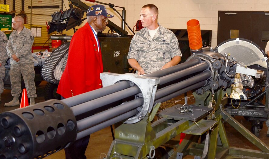 Tuskegee Airman Dr. Cyril O. Byron, Sr. listens to Master Sgt. John Lamar of the 175th Maintenance Squadron while getting a close up look at an A-10C's 30mm gun at Warfield Air National Guard Base Saturday, August 11th. Byron toured the base after helping  with a promotion ceremony for Senior Master Sgt. Ed Bard. (National Guard photo Tech. Sgt. Chris Schepers)