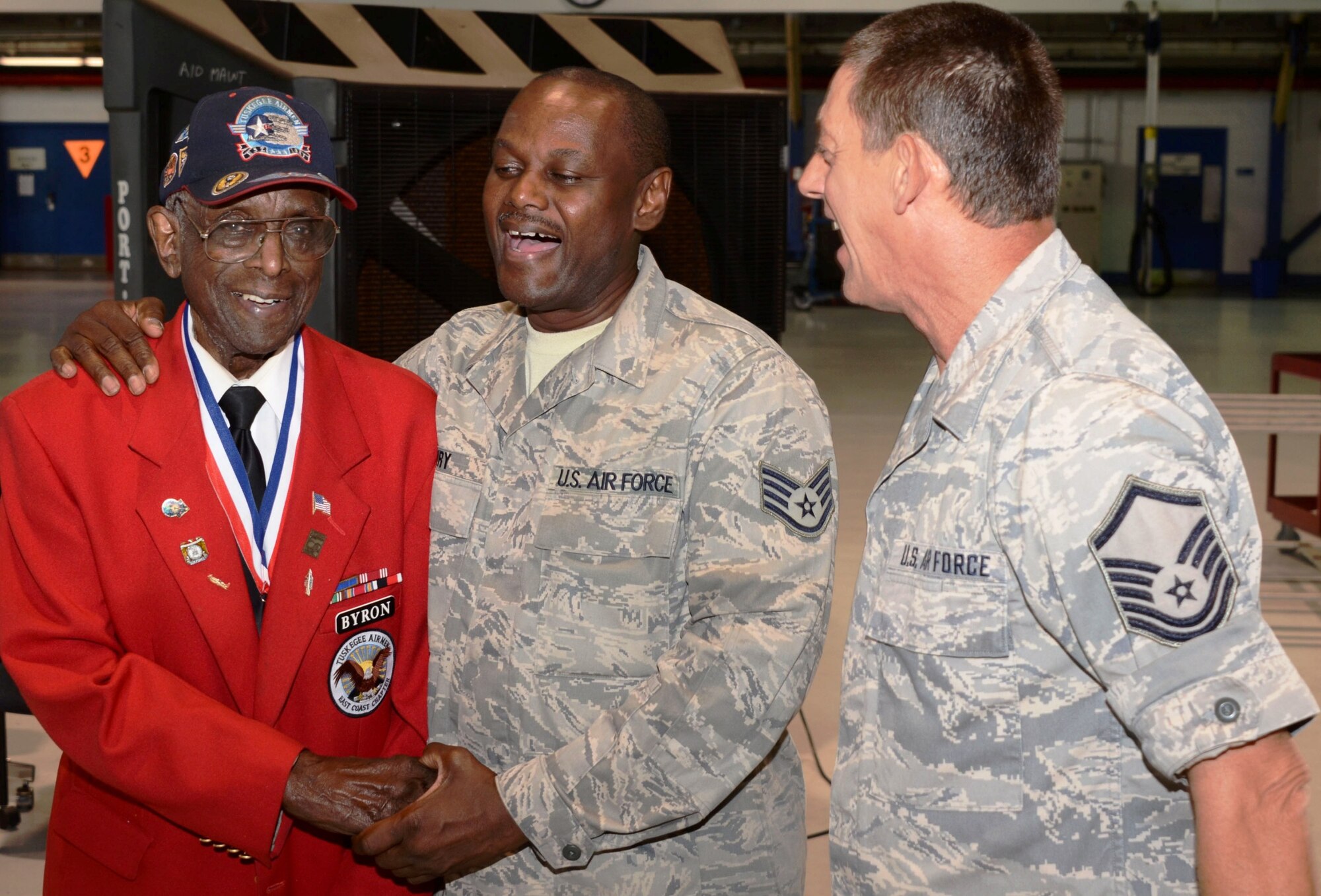 Tuskegee Airman Dr. Cyril O. Byron, Sr. shares a laugh with Staff Sgt. Marlon Henry and Master Sgt. James Chrismond of the 175th Maintenance Squadron while getting a close up look at an A-10C at Warfield Air National Guard Base Saturday, August 11th. Byron toured the base after helping with a promotion ceremony for Senior Master Sgt. Ed Bard. (National Guard photo Tech. Sgt. Chris Schepers)