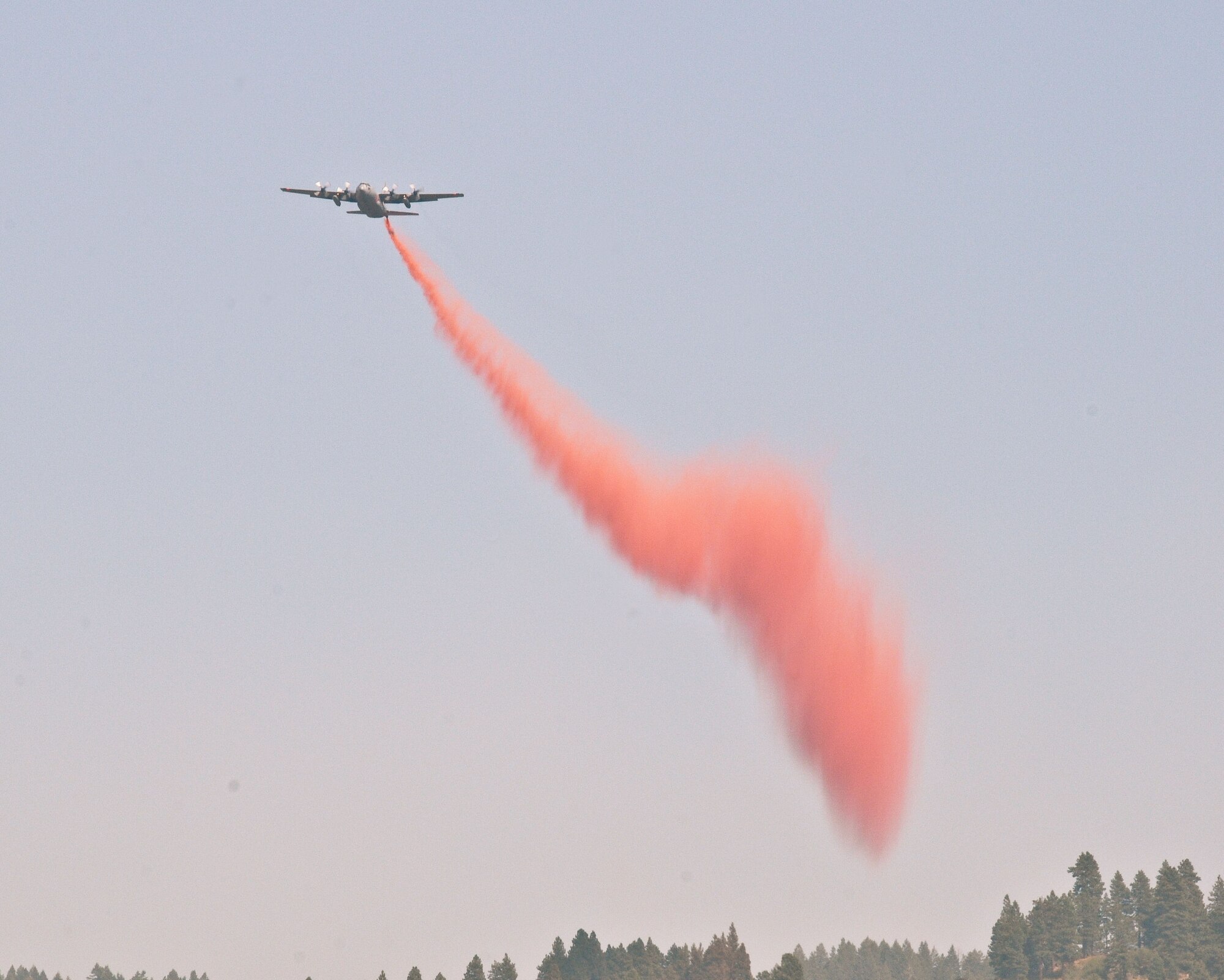 A C130-H from the 302nd Air Force Reserve Command drops retardant near the Springs fire north of Eagle, Idaho Aug. 9, 2012. The 146th Airlift Wing currently has two C130-Js equipped with MAFFS assisting U.S. Forest Service with wildfire suppression in Boise, Idaho. (U.S. Air Force photo by: Master Sgt. Dave Buttner)