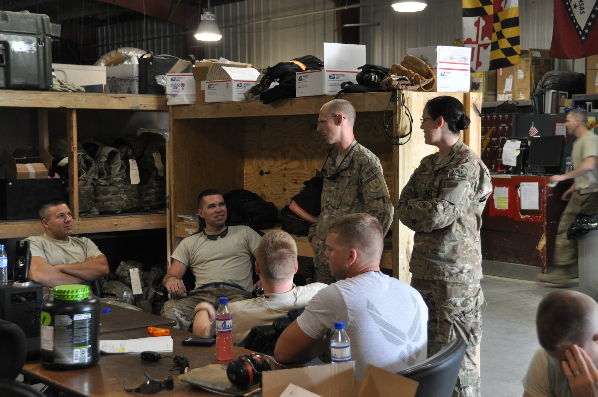 Chaplain (Capt.) Molly Lawlor (right), 455th Air Expeditionary Wing Flightline Chaplain, and TSgt Steven James, Chaplain's Assistant, regularly meet with pilots, maintainers, and support personnel between devotionals and worship services at Bagram Airfield, Afghanistan, July 29, 2012. The Chaplain Corps' Religious Support Teams provide a mission-specific "visual reminder of the holy" for various units in a deployed environment. (U.S. Air Force photo/TSgt Shawn McCowan)