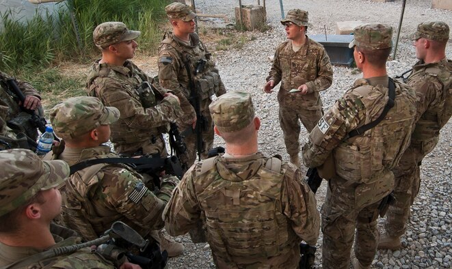 Chaplain (Capt.) Joshua King (right), 455th Expeditionary Security Force Squadron Chaplain, offers an informal worship service to ESFS Airmen before shift change at Bagram Airfield, Afghanistan, July 27, 2012. The work Religious Support Teams do while deployed served as the inspiration behind the Chaplain Corps' new program. (U.S. Air Force Photo/Capt. Raymond Geoffroy) 