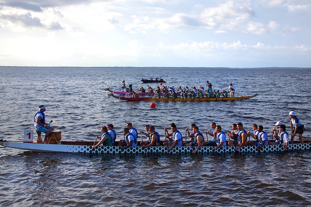 Three teams participating in a dragon boat race on the Neuse River, line up at the starting line Saturday, in Oriental, N.C. Immediately following the first race, the second trio of boats was in the water heading to the starting line.