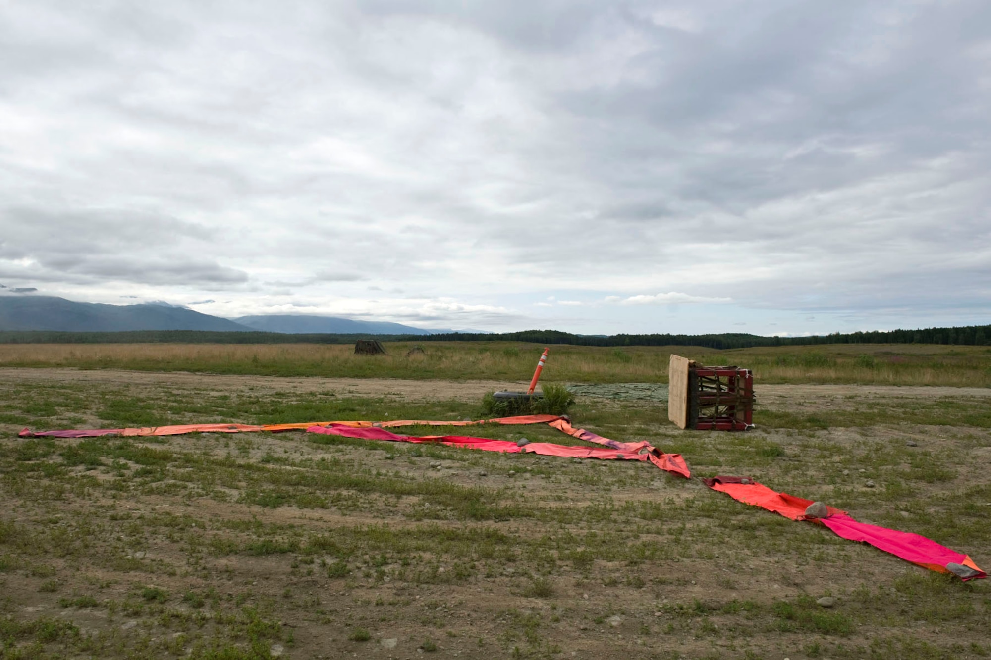 JOINT BASE ELMENDORF-RICHARDSON, Alaska - Two training container delivery systems (CDS) lay next to a target point at the Malamute Drop Zone here Aug. 11, 2012. The CDSs are attached to parachutes and are used in airdrops by military cargo aircraft. During wartime and humanitarian missions, they carry supplies such as food or ammunition to areas that cannot otherwise be reached. These CDSs were used by Alaska Air National Guard's 176th Wing's airlift squadrons participating in a "Moose Shoot" -- an airdrop and landing competition. Also participating were the JBER-based 517th and 537th airlift squadrons of the active-duty Air Force. (National Guard photo by Master Sgt. Shannon Oleson)