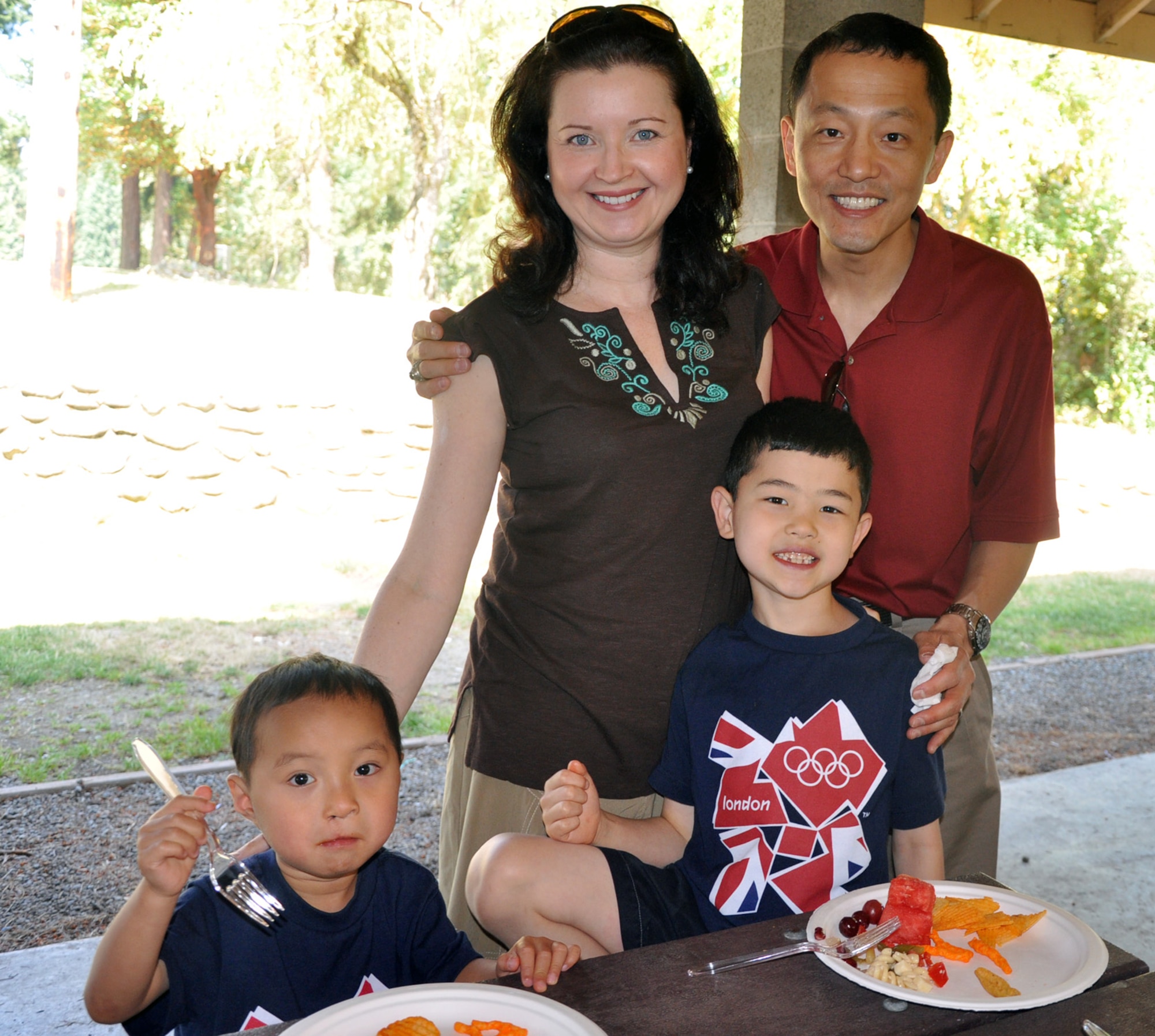 Lt. Col. Steven Lee, 446th Airlift Wing Inspector General, with his wife Suzanne, 7-year-old Alexander and 3-year-old Nathaniel, enjoy food and festivities during the 446th AW Family Day picnic here, Aug. 11.  Reservists shared an afternoon honoring their families who support 446th AW Reservists’ missions around the world on a daily basis.  (U.S. Air Force photo by Tech. Sgt. Elizabeth Moody)