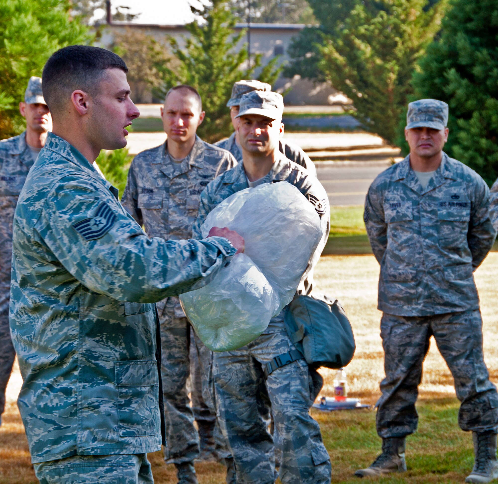 Tech. Sgt Justin Shattuck, 446th Civil Engineer Squadron emergency manager, shows Citizen Airmen how to properly dispose of contaminated materials during a training session held here Aug. 12, 2012.  The training enhances the wing's readiness and ability to succeed as they focus on preparing for the Operational Readiness Inspection in October 2012. (U.S. Air Force photo by Tech. Sgt. Tanya King)